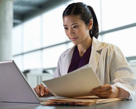 doctor health professional reviewing documents coding